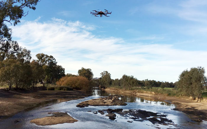 A drone flying over a creek